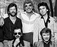 Eric Clapton, Carl Perkins, George Harrison, Ringo Starr, Dave Edmunds in Blue Suede Shoe (1985).