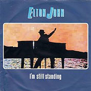 I'm Still Standing / Earn While You Learn, The Rocket Record Company UK, EJS 1, Jule 03, 1983, 7″45 RPM.